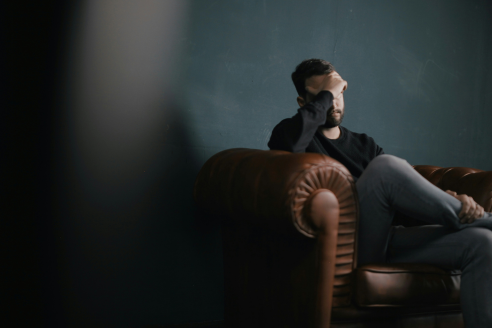 man sitting on couch 492x328 px